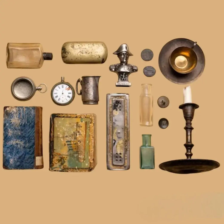 An assortment of vintage items elegantly arranged against a warm brown backdrop highlighting their craftsmanship & age.