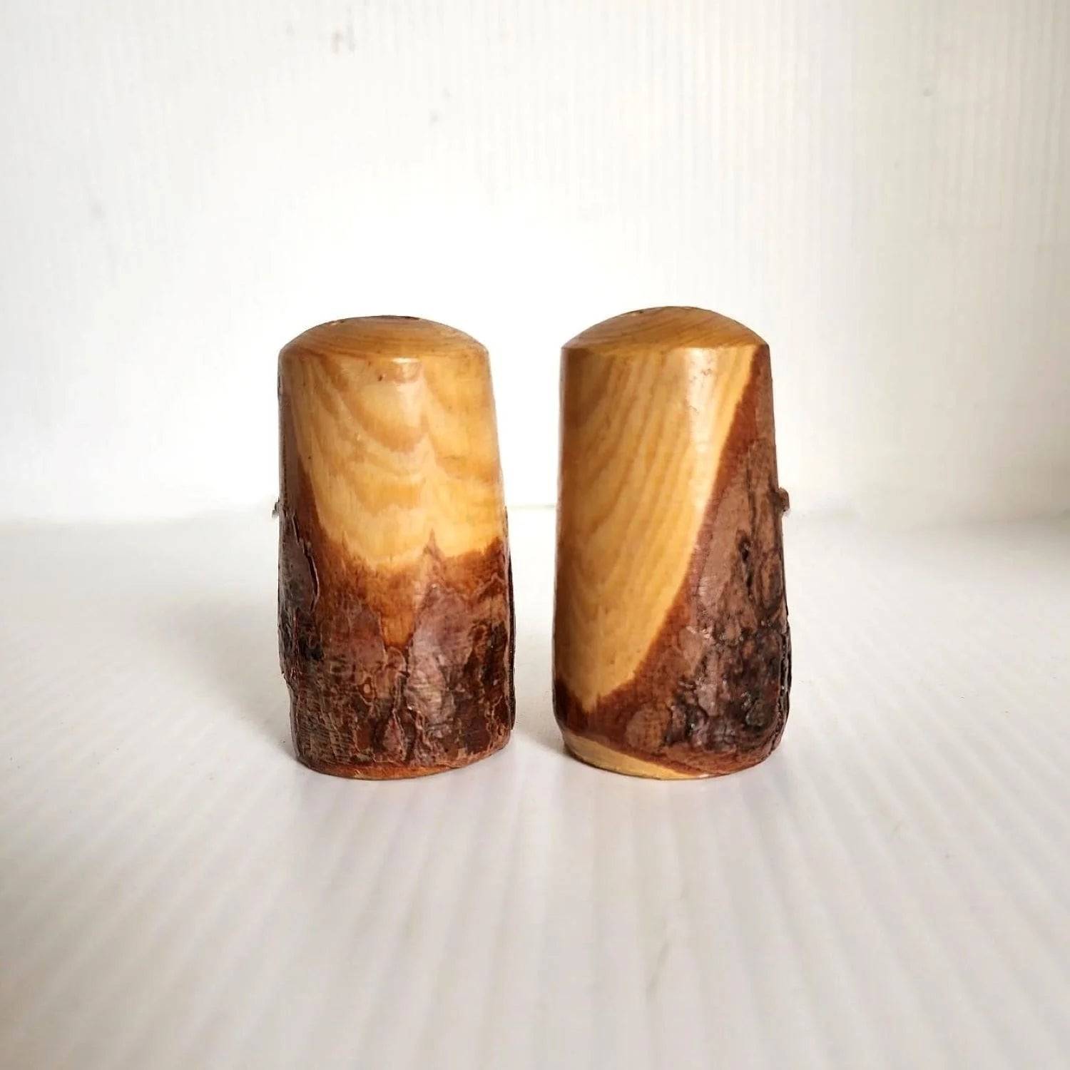 Wooden salt and pepper shakers featuring deer designs.