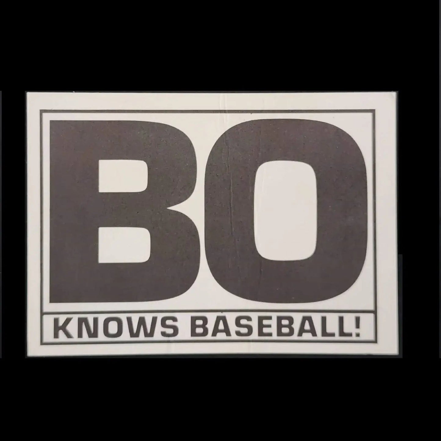 Black and white picture of a Bo Jackson gripping a baseball bat.