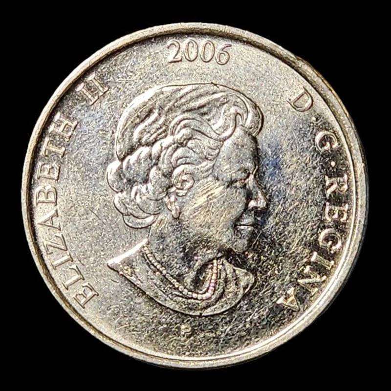 Canadian coin with pink ribbon, symbolizing support for breast cancer awareness.