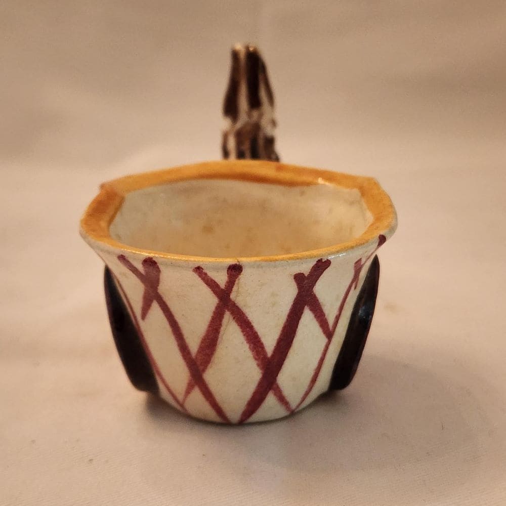 A ceramic donkey with a wheelbarrow, showcasing a whimsical and charming display of craftsmanship.