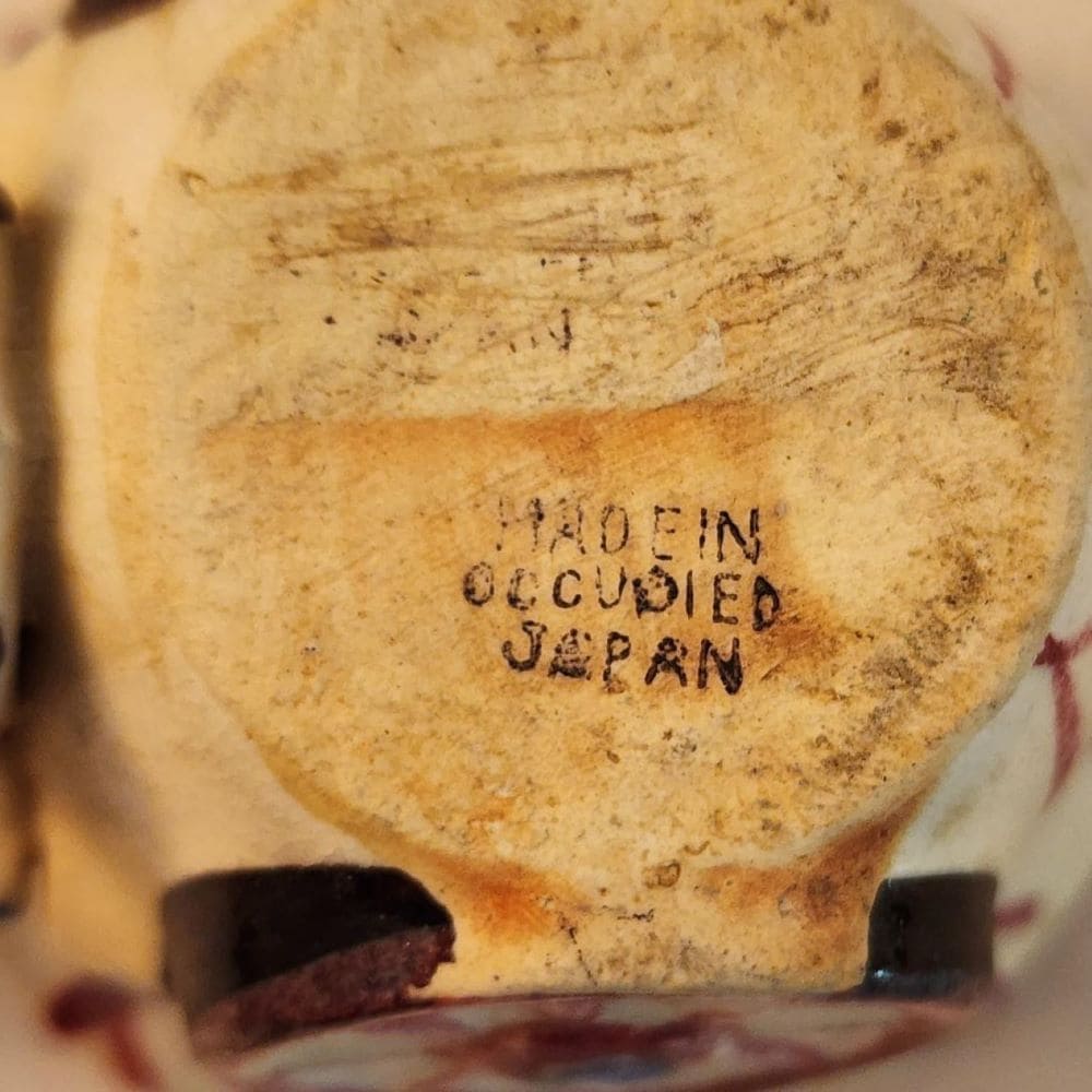 A ceramic donkey with a wheelbarrow, showcasing a whimsical and charming display of craftsmanship.