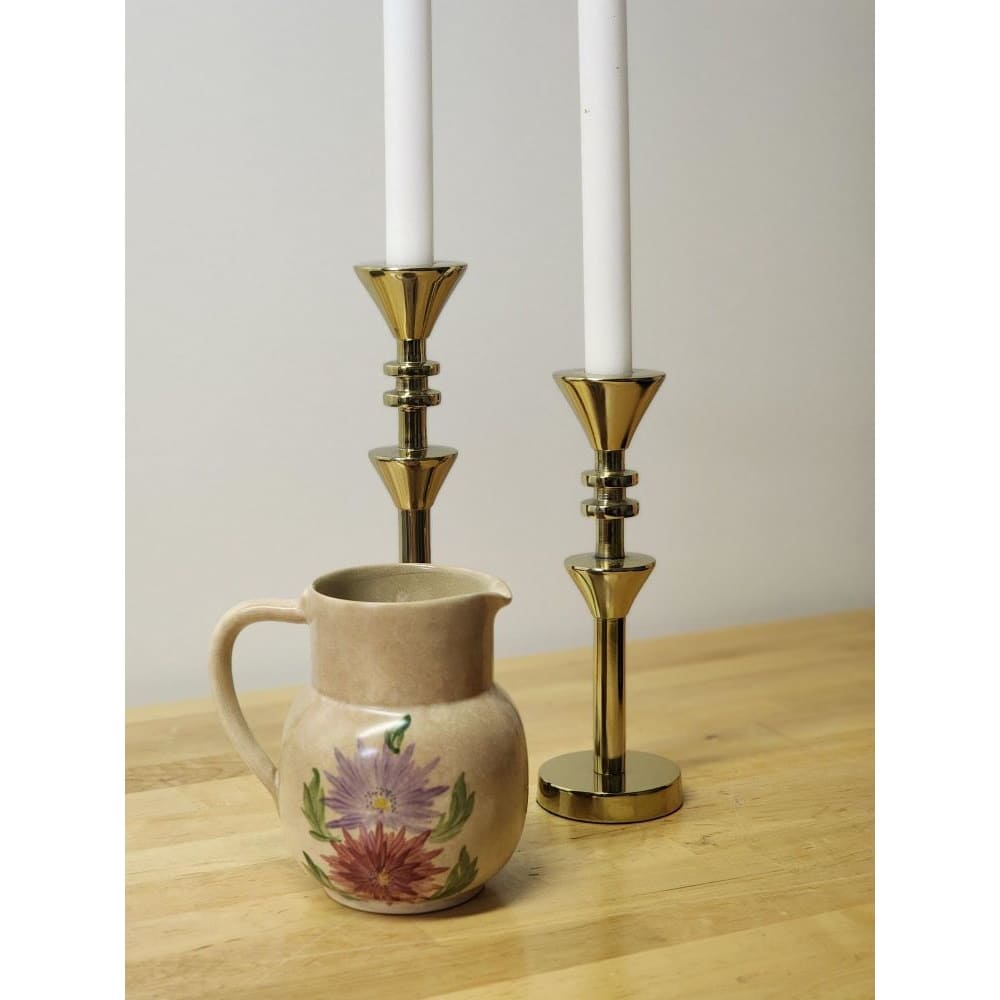 A pitcher featuring a beautiful floral design, hand-painted for a charming touch.