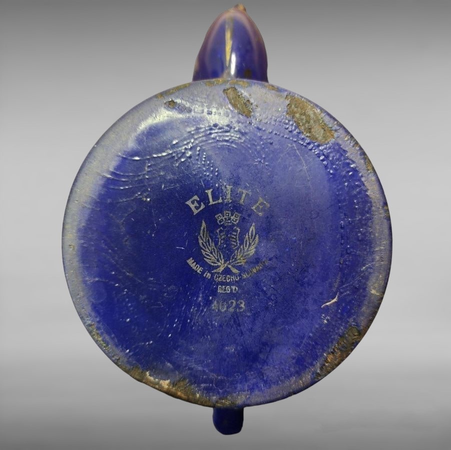 A blue teapot with gold flowers and images all over.