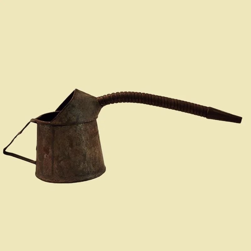 An antique jug with a lengthy nose, perfect for tending to automotive needs