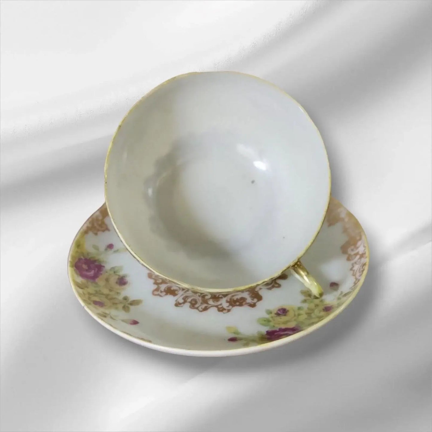 Cup and saucer on two books, creating a cozy reading nook.