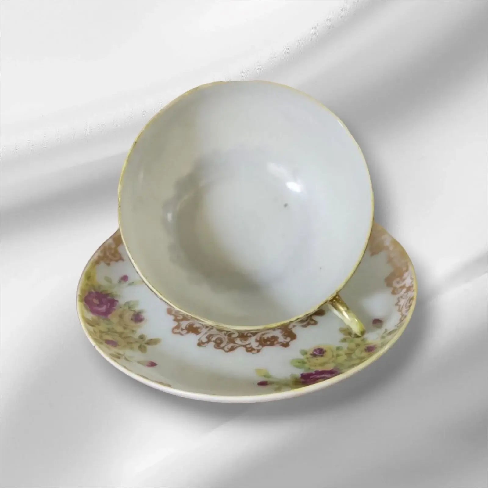 Cup and saucer on two books, creating a cozy reading nook.