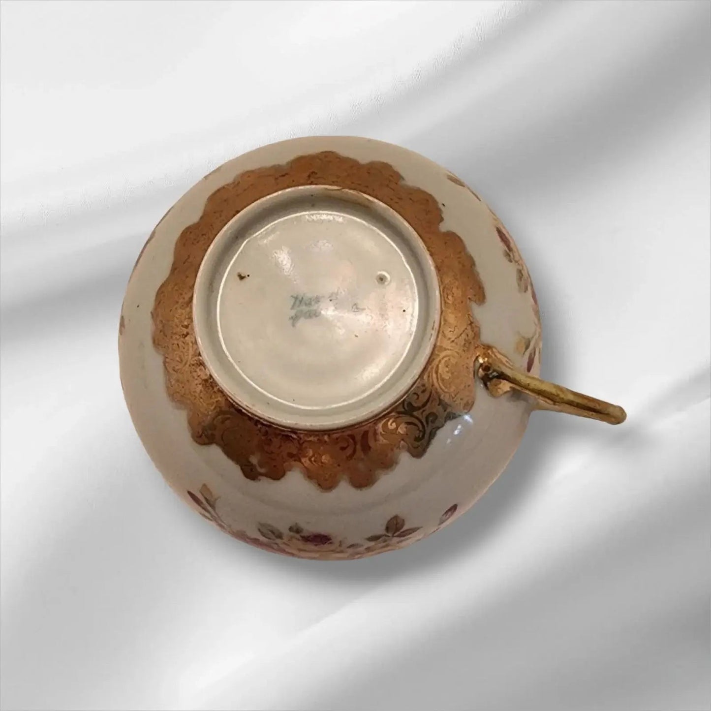 Cup and saucer on two books, creating a cozy reading nook.