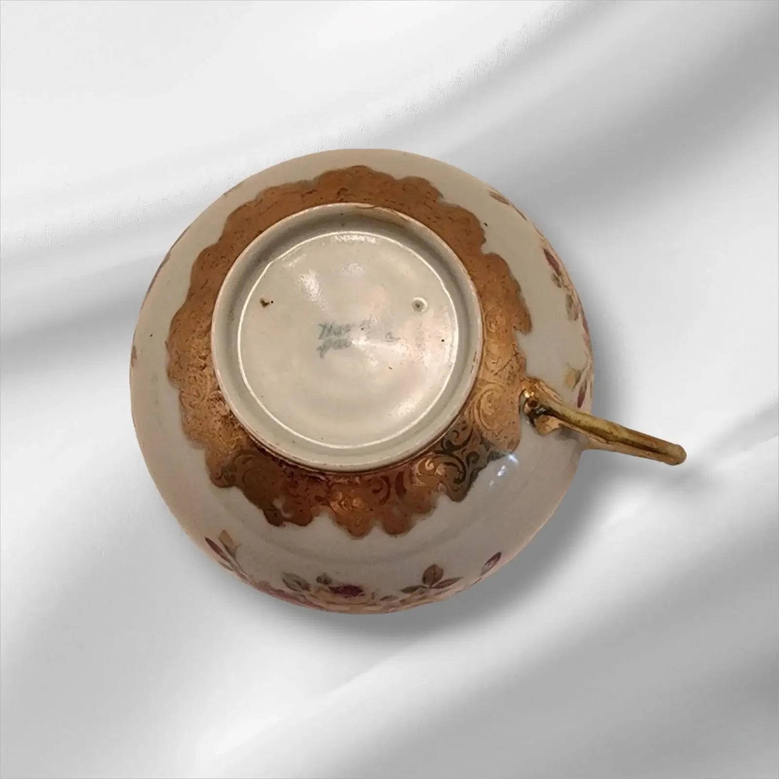 Cup and saucer on two books, creating a cozy reading nook.