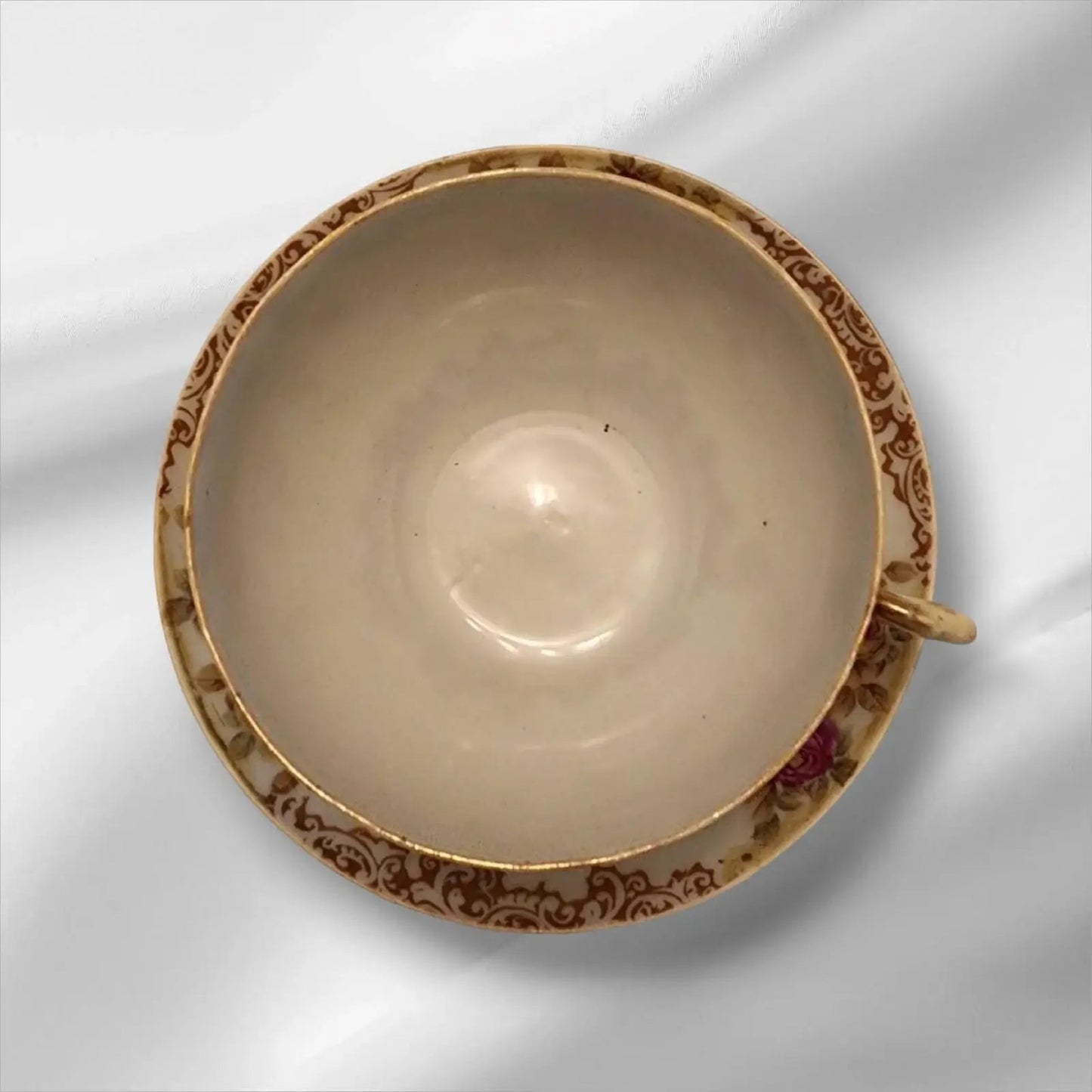 Cup and saucer on two books, creating a cozy reading nook.