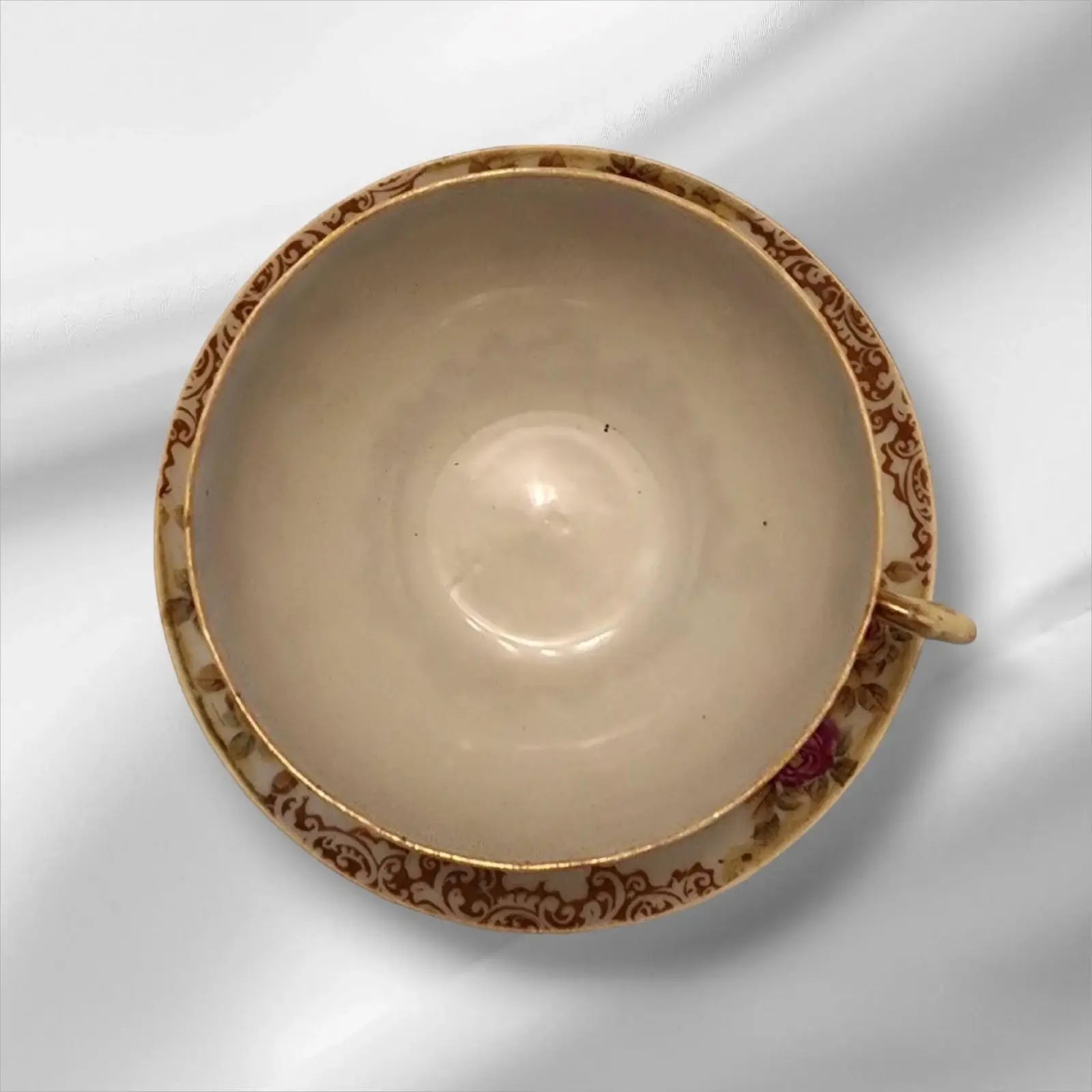 Cup and saucer on two books, creating a cozy reading nook.