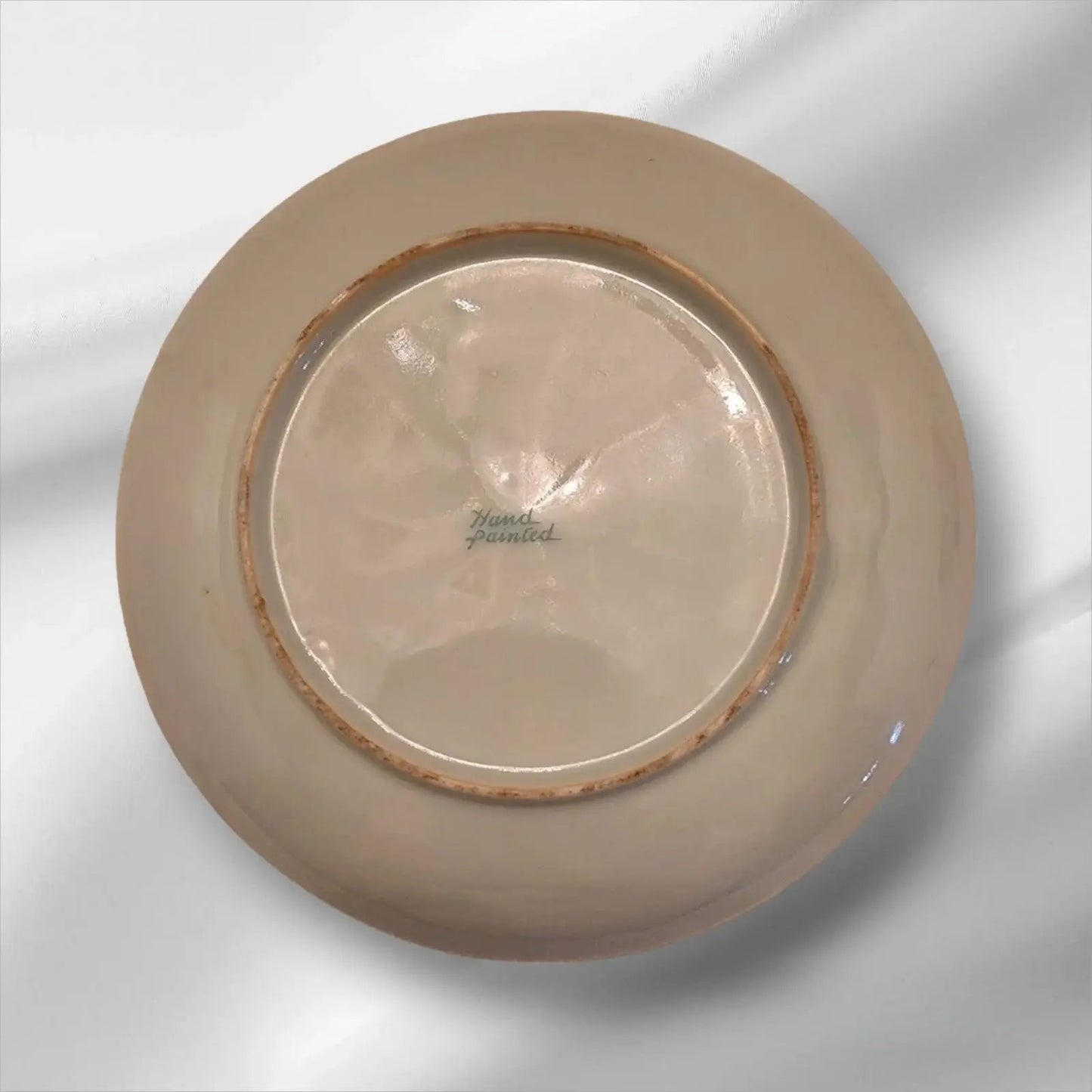 Cup and saucer on two books, creating a cozy reading nook.