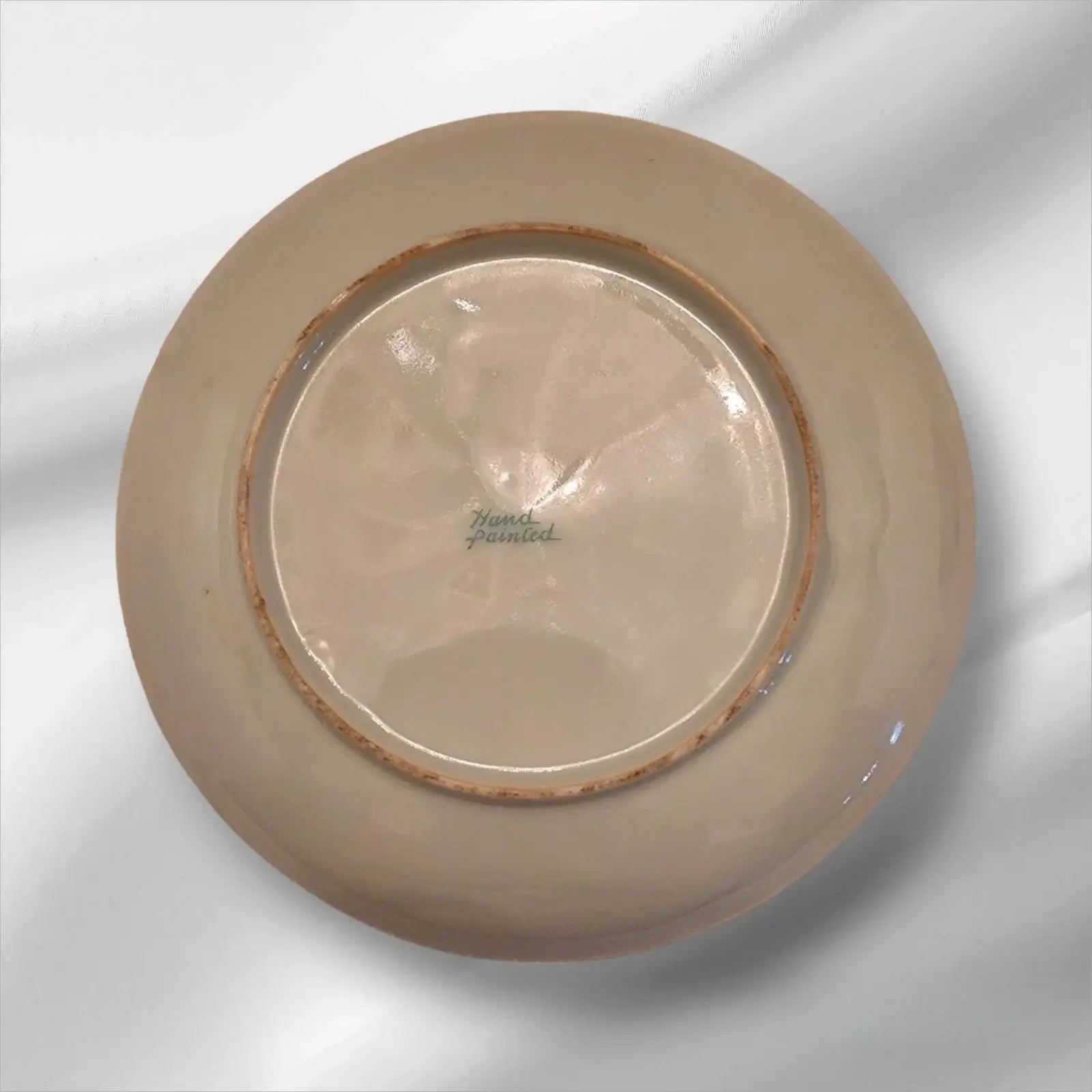 Cup and saucer on two books, creating a cozy reading nook.