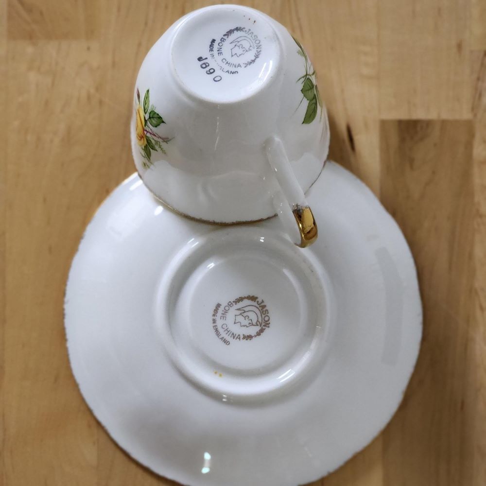 A tea cup and saucer resting on a book, creating a serene and cozy scene.