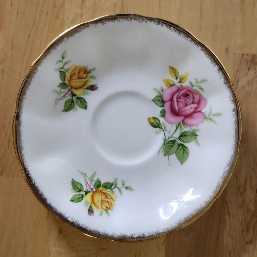 A tea cup and saucer resting on a book, creating a serene and cozy scene.