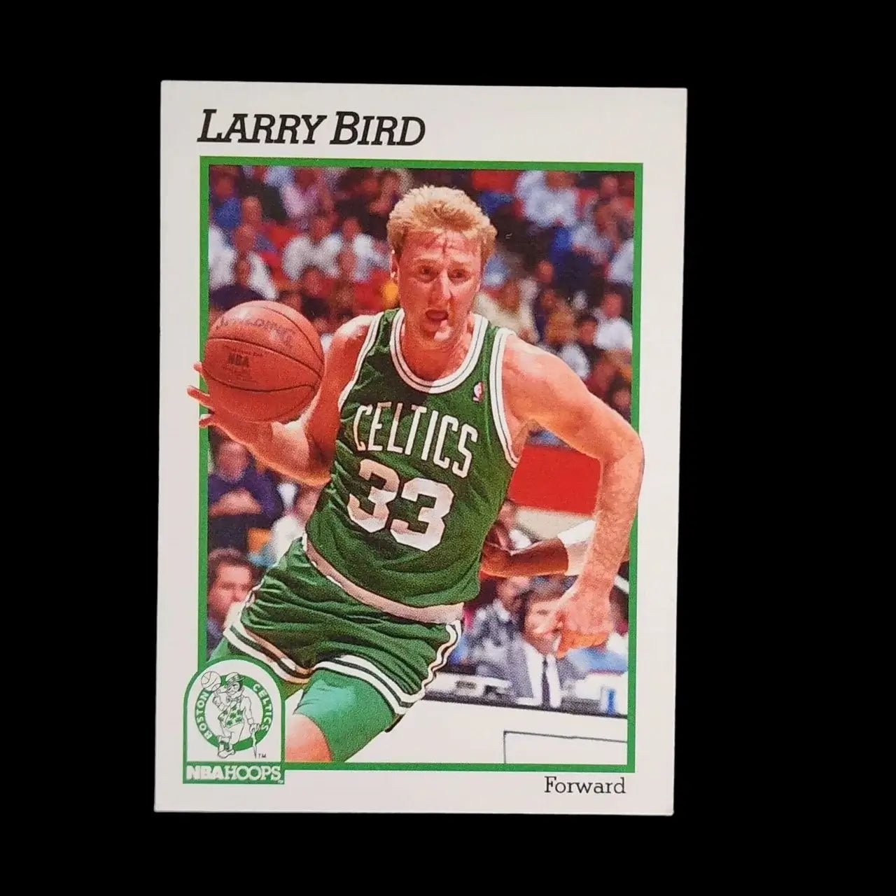 Sports trading card of Larry Bird in action.