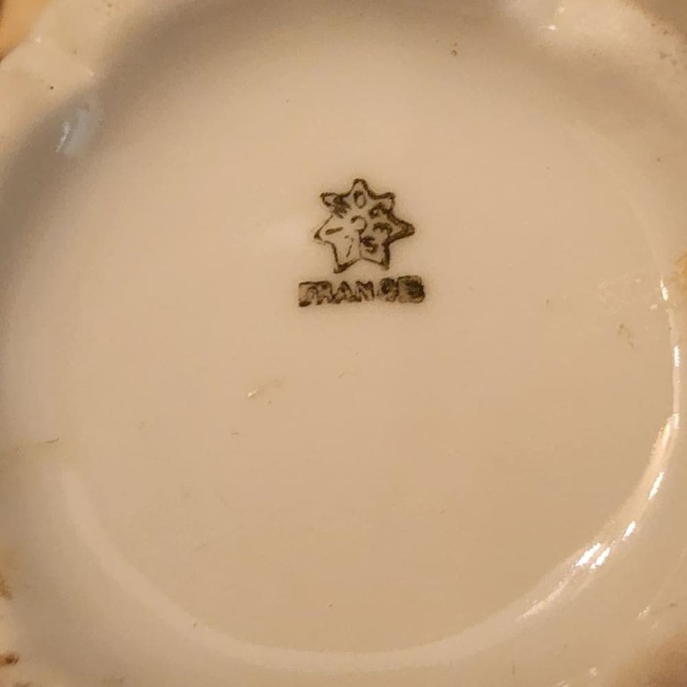 Two candles on a tray with a small cup, creating a serene ambiance.