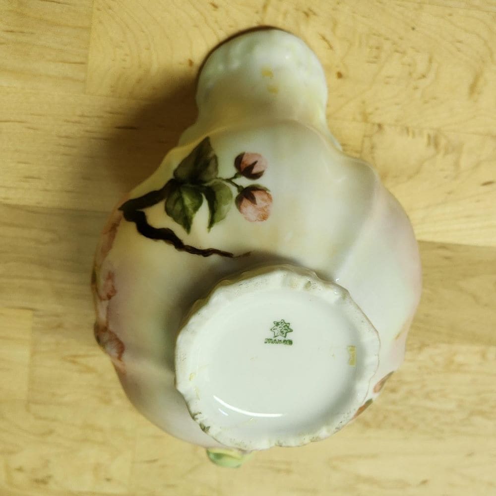 Two candles on a tray with a small cup, creating a serene ambiance.