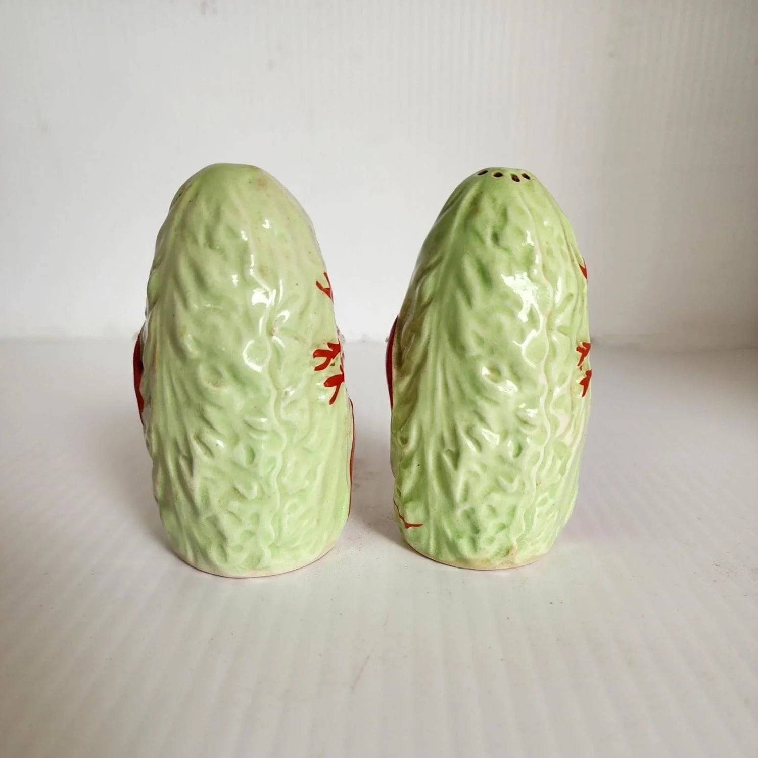 Two ceramic lobster salt and pepper shakers on a table.