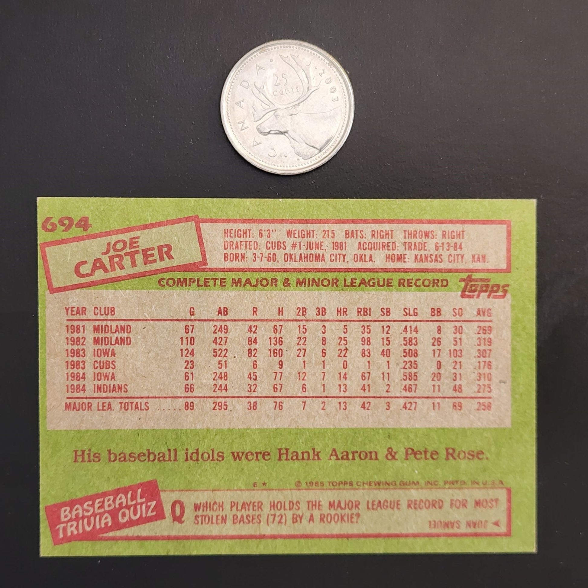 A baseball card featuring a coin beside it, showcasing a valuable collectible item.