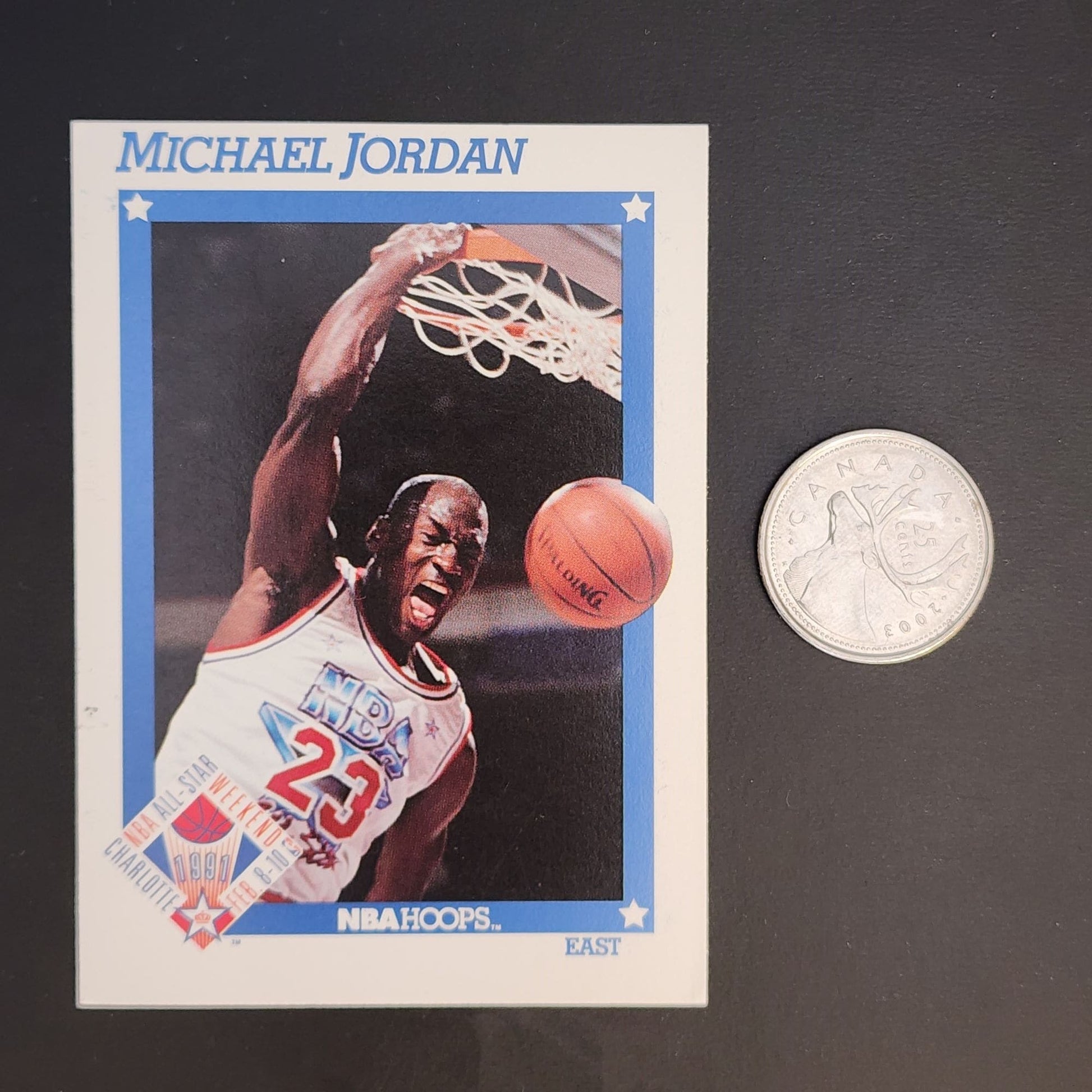 Basketball card featuring Michael Jordan beside a quarter.