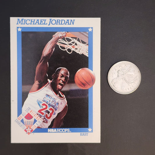 Basketball card featuring Michael Jordan beside a quarter.