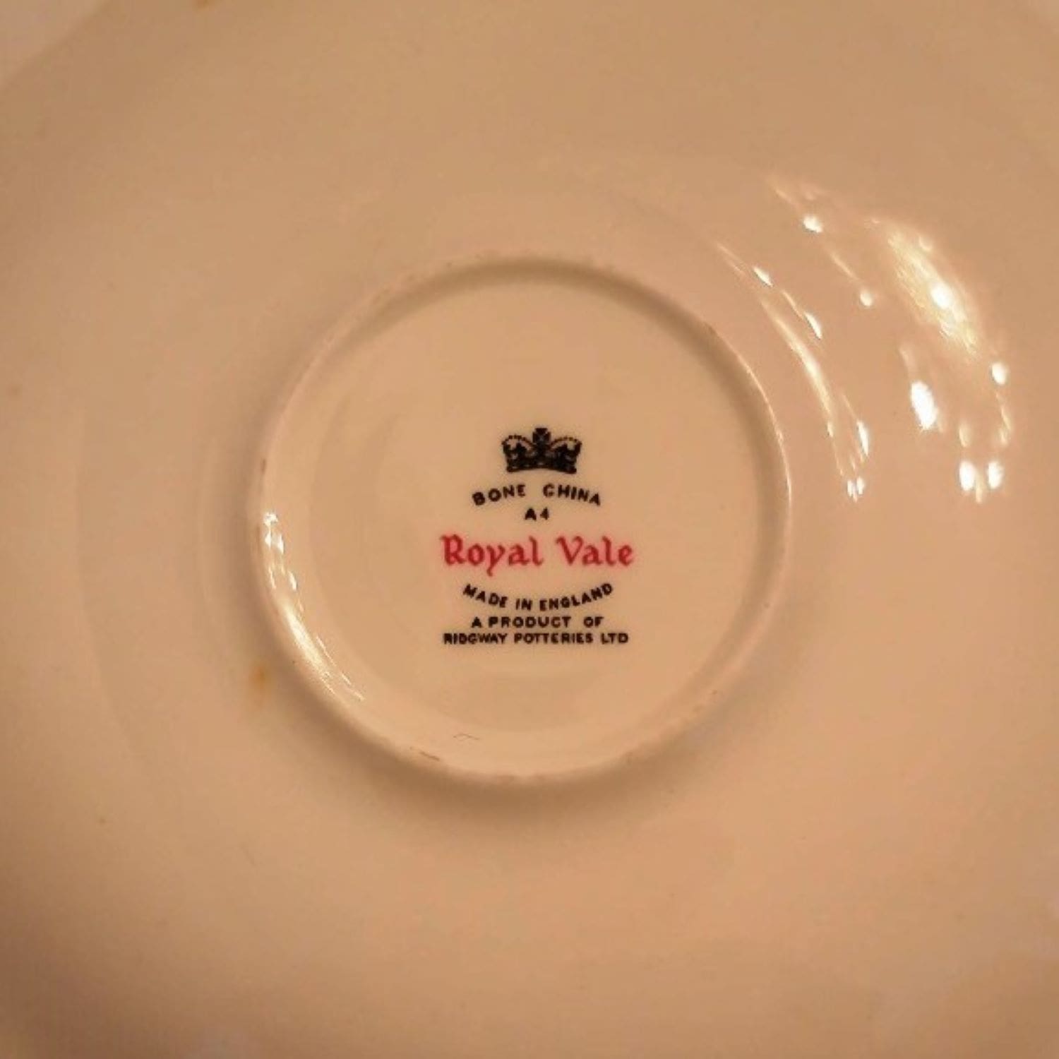 A tea cup and saucer featuring a delicate blue rose design.