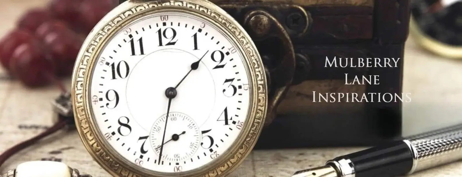 Antique pocket watch with pen on a counter