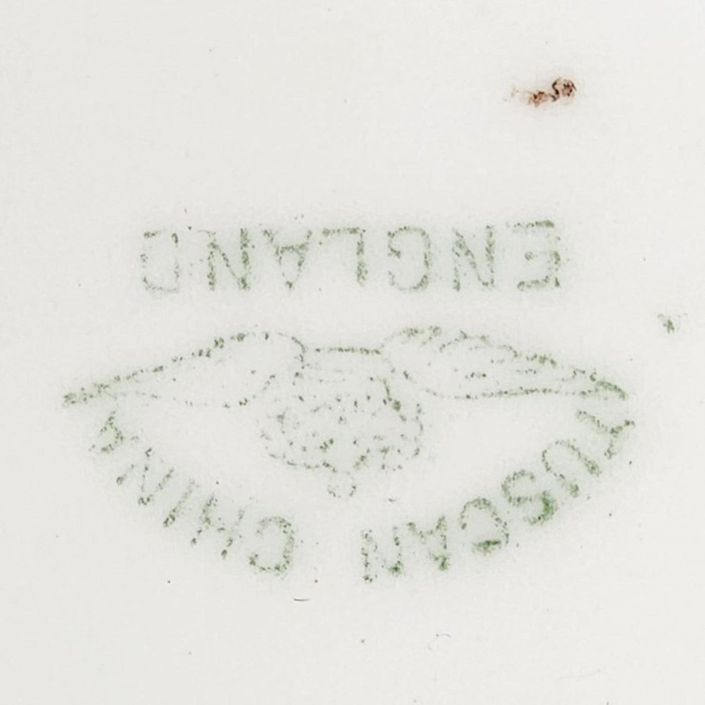 A blue and gold plate featuring a painting of a man and woman.