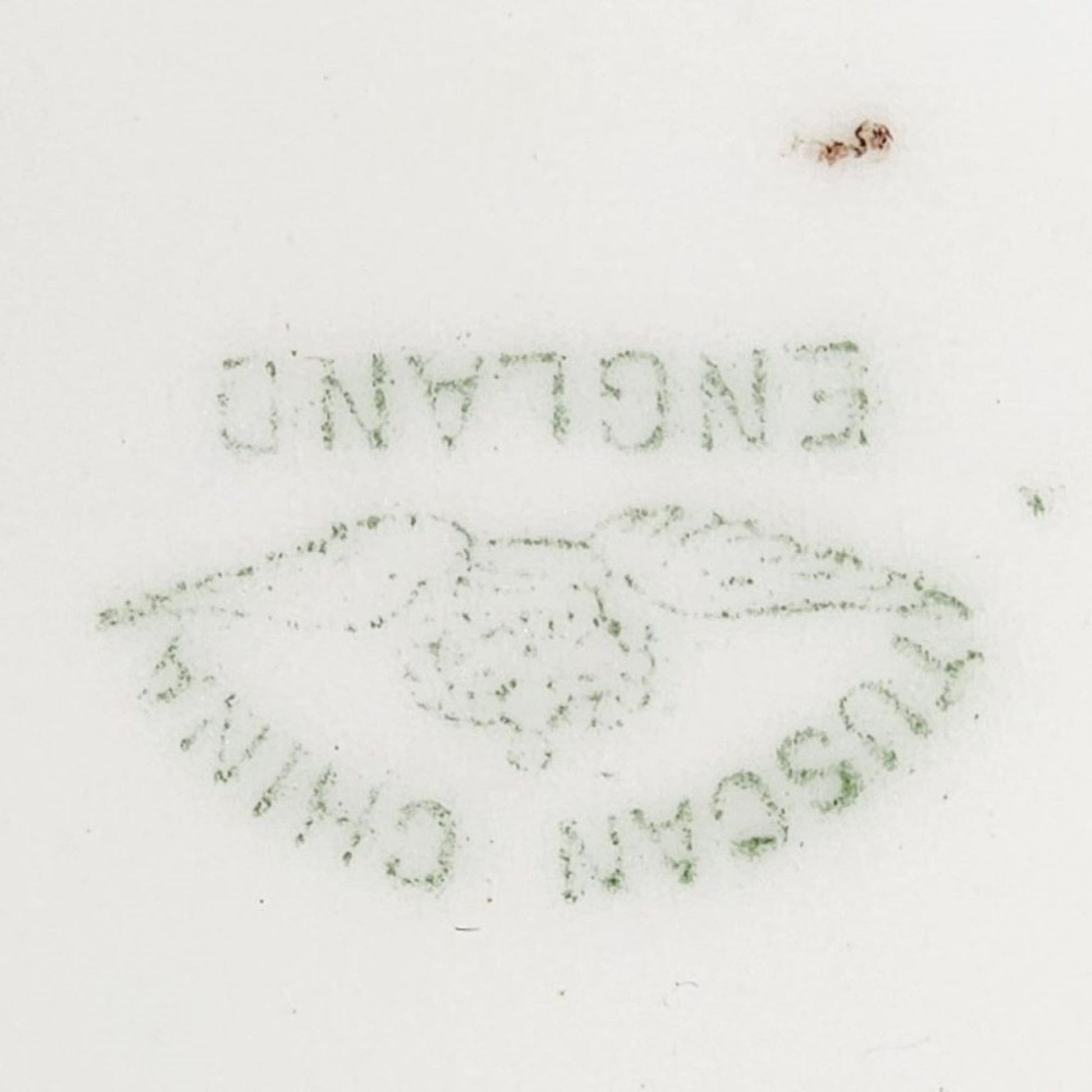 A blue and gold plate featuring a painting of a man and woman.