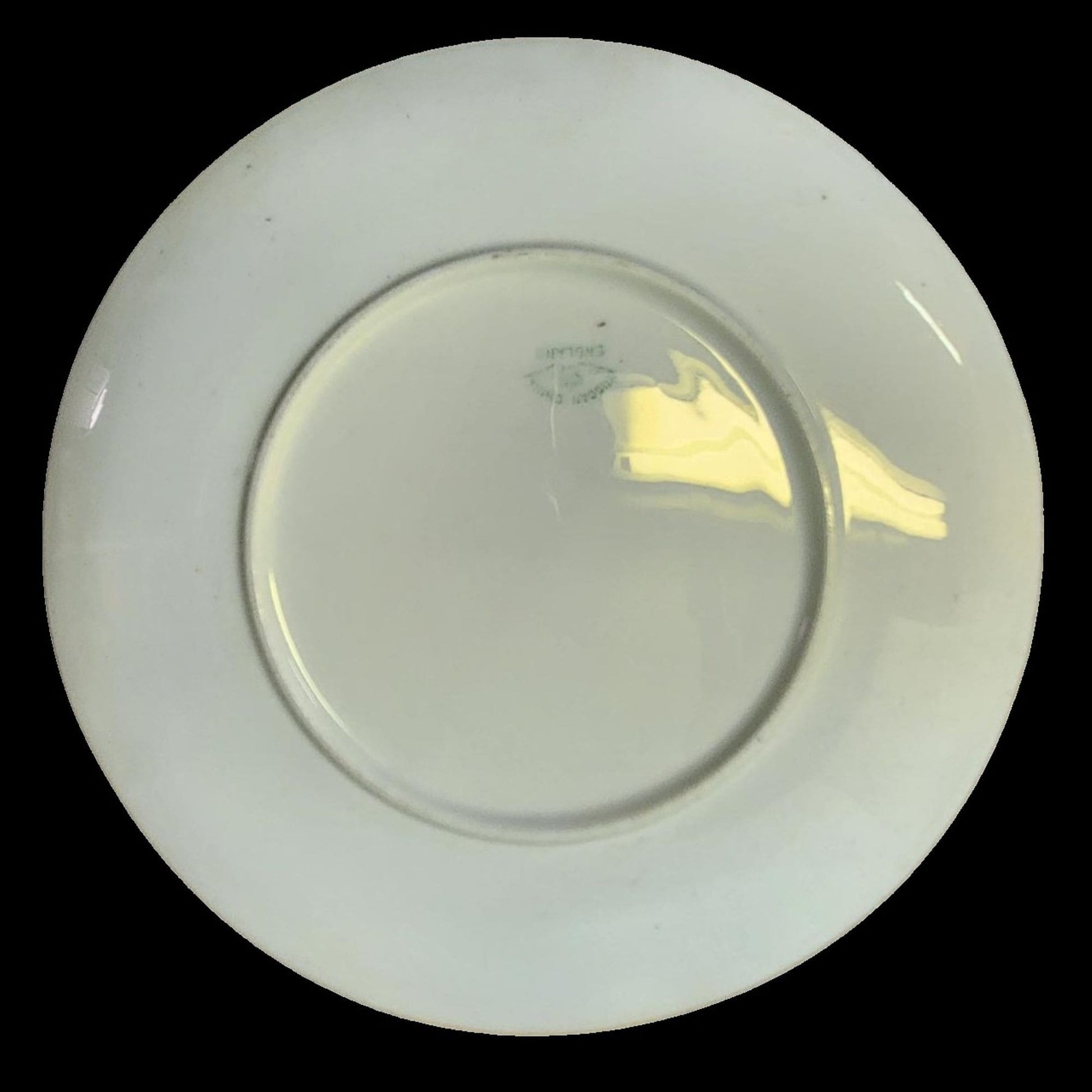 A blue and gold plate featuring a painting of a man and woman.