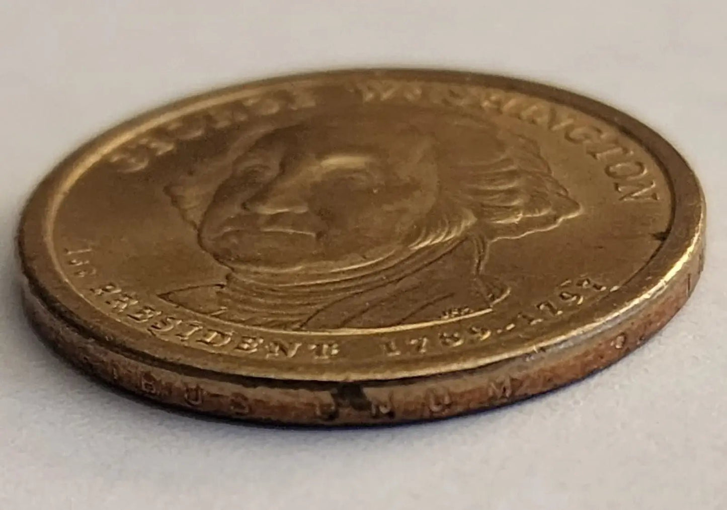 George Washington depicted on a gold coin, representing the first President of the United States.