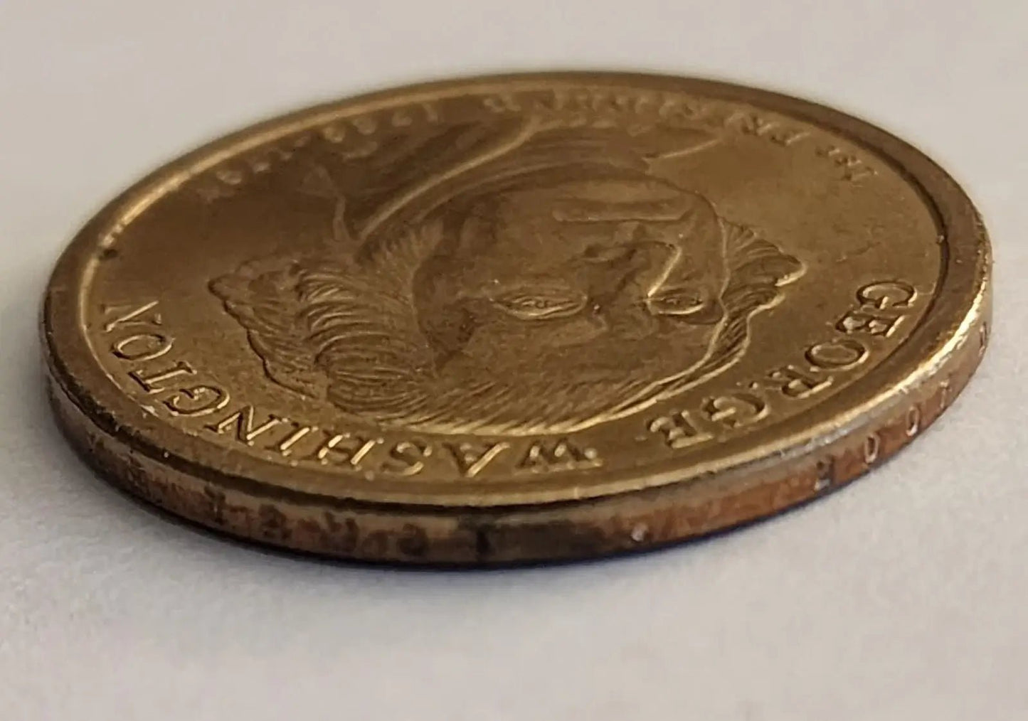 George Washington depicted on a gold coin, representing the first President of the United States.