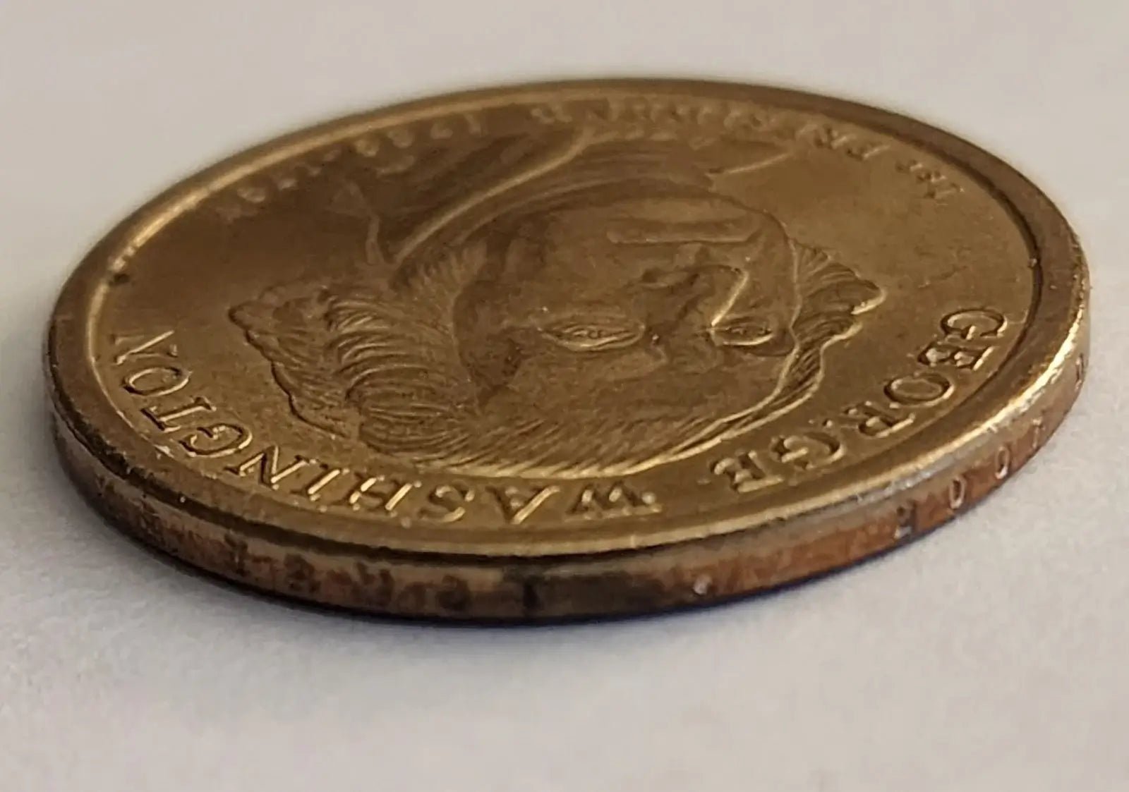 George Washington depicted on a gold coin, representing the first President of the United States.