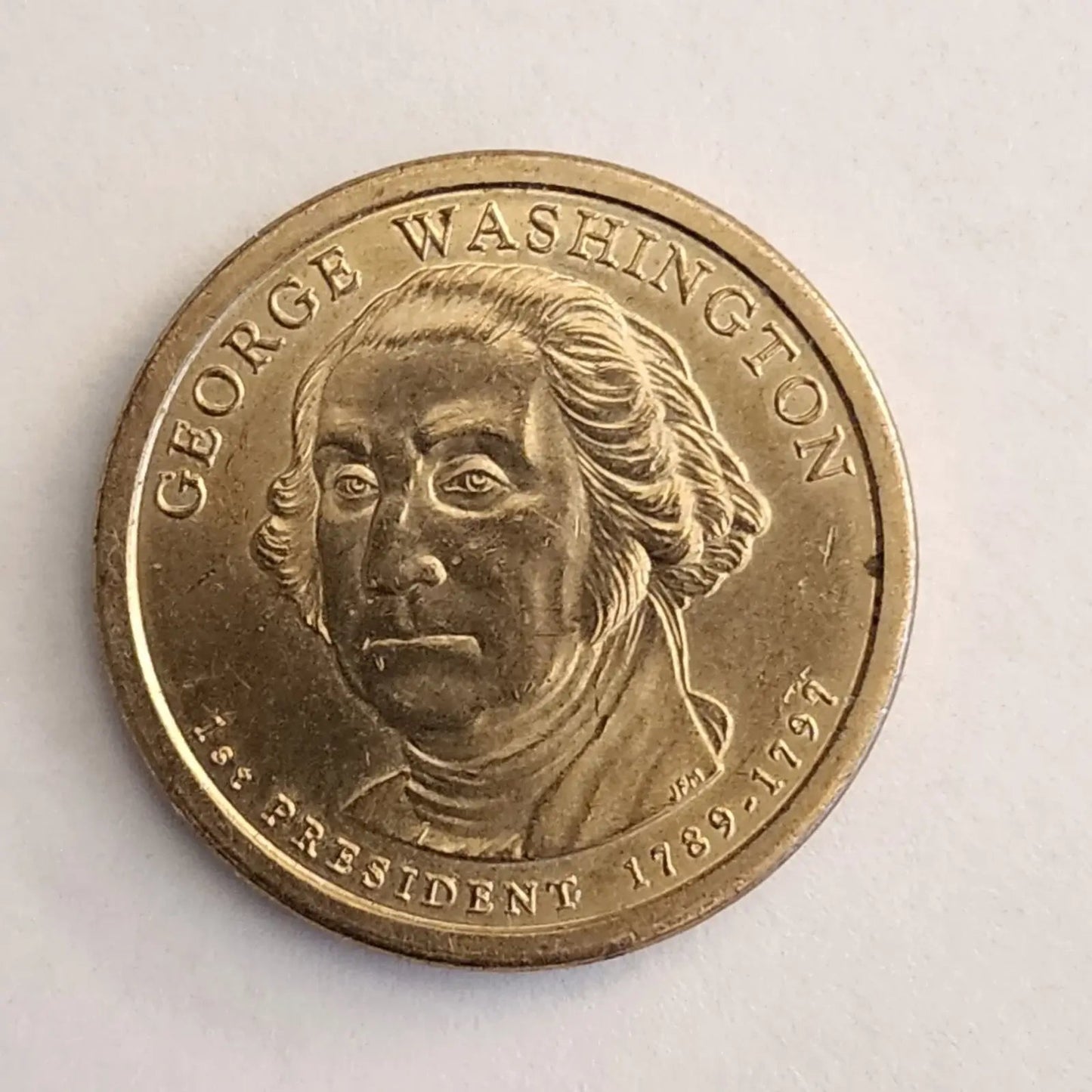 George Washington depicted on a gold coin, representing the first President of the United States.
