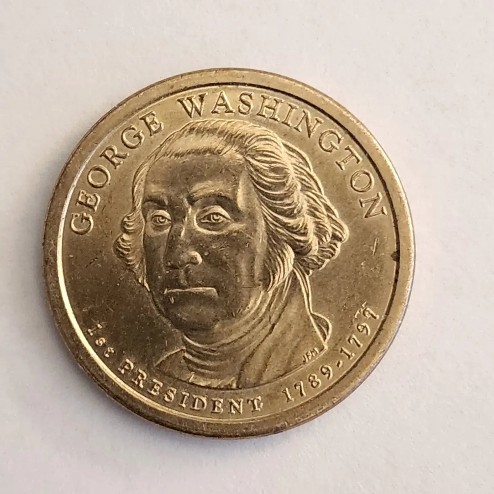 George Washington depicted on a gold coin, representing the first President of the United States.