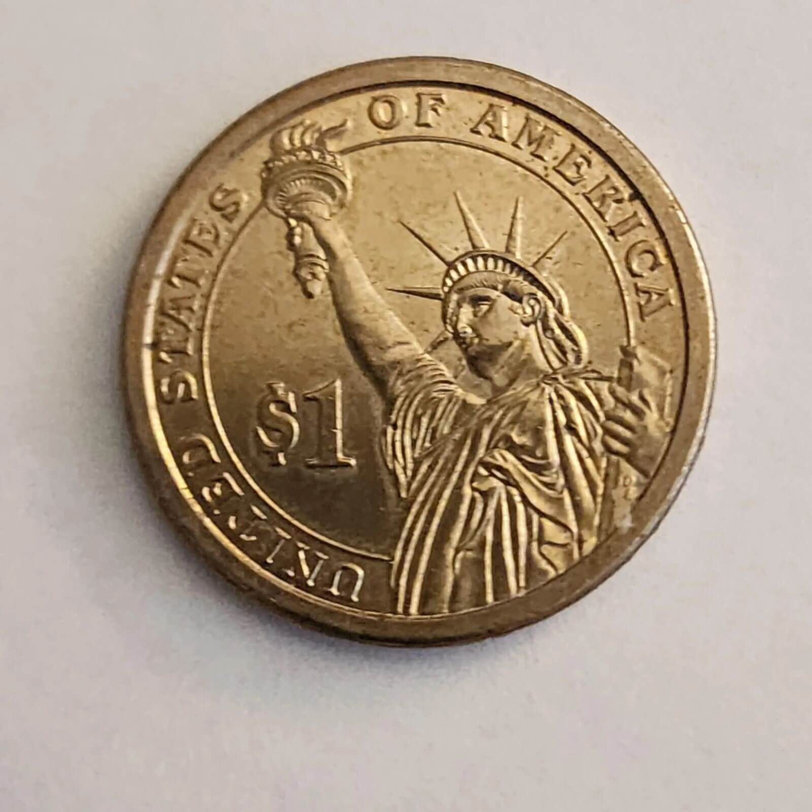 George Washington depicted on a gold coin, representing the first President of the United States.