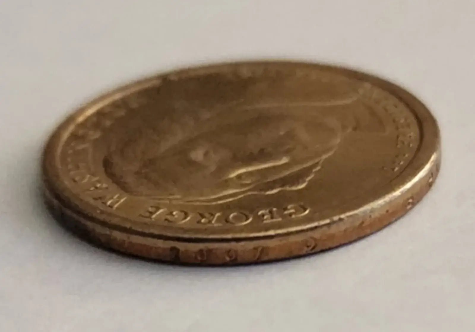 George Washington depicted on a gold coin, representing the first President of the United States.