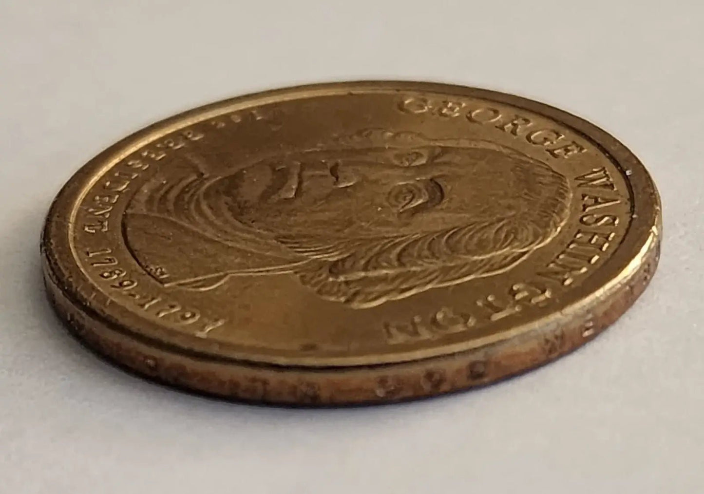 George Washington depicted on a gold coin, representing the first President of the United States.