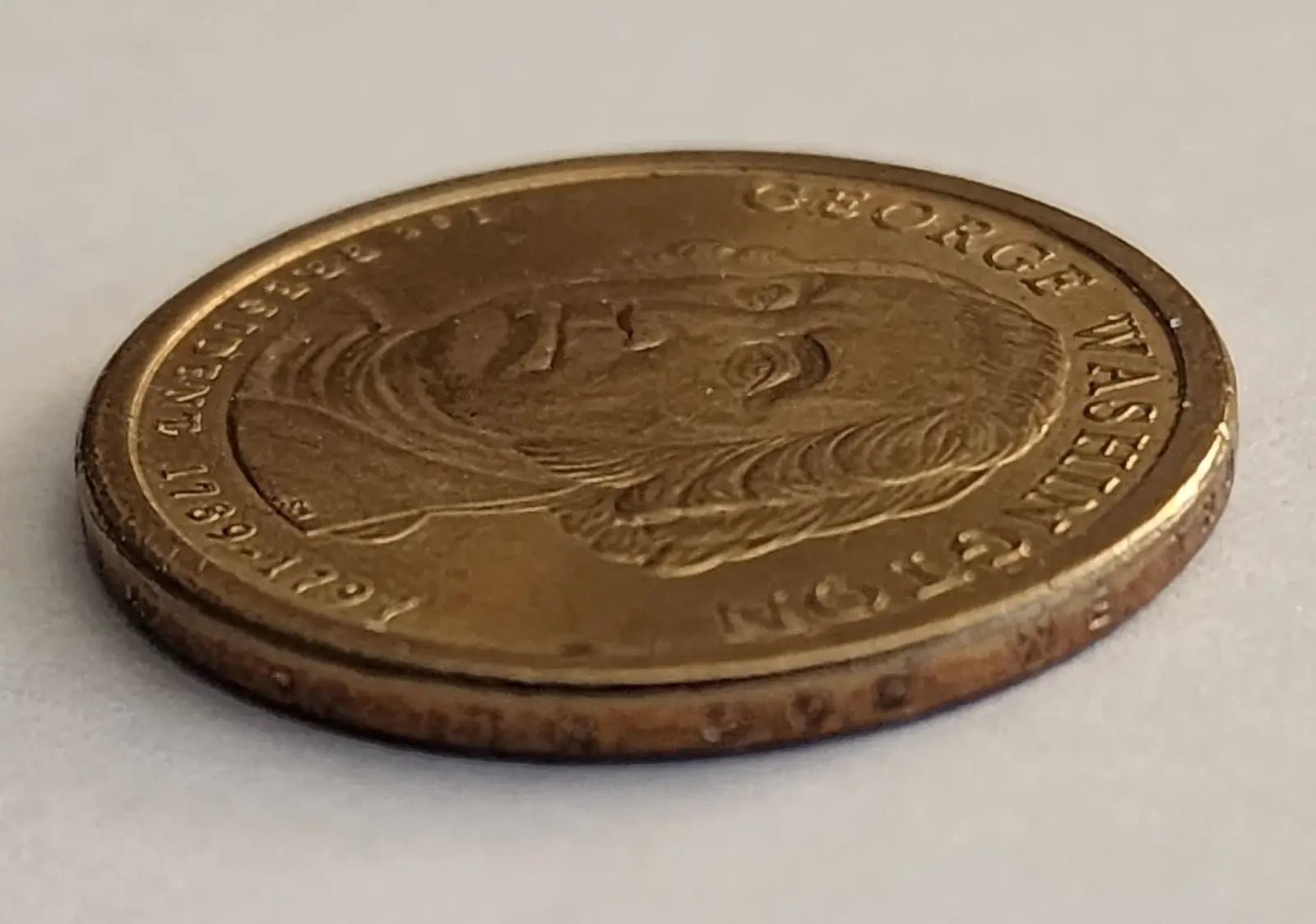George Washington depicted on a gold coin, representing the first President of the United States.
