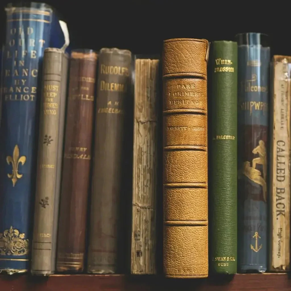 A collection of old books neatly arranged on a wooden shelf, showcasing their worn spines and vintage covers.