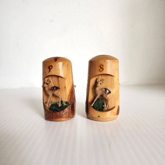 Wooden salt and pepper shakers featuring deer designs.