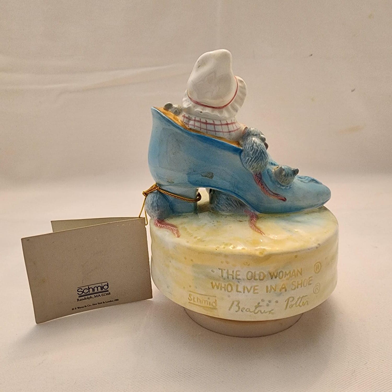 A mouse figurine perched on a shoe.