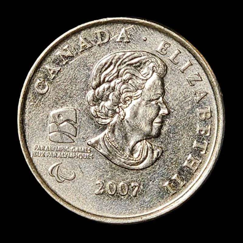 A coin featuring a man in a wheelchair seated on it, symbolizing inclusivity and representation.