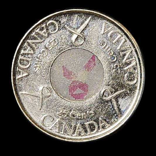 Canadian coin with pink ribbon, symbolizing support for breast cancer awareness.