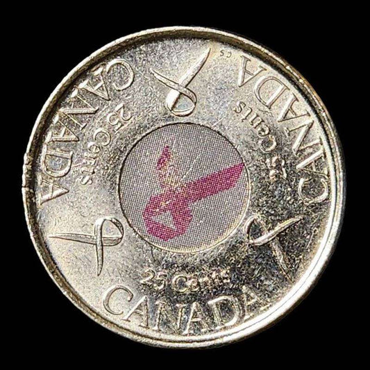 Canadian coin with pink ribbon, symbolizing support for breast cancer awareness.