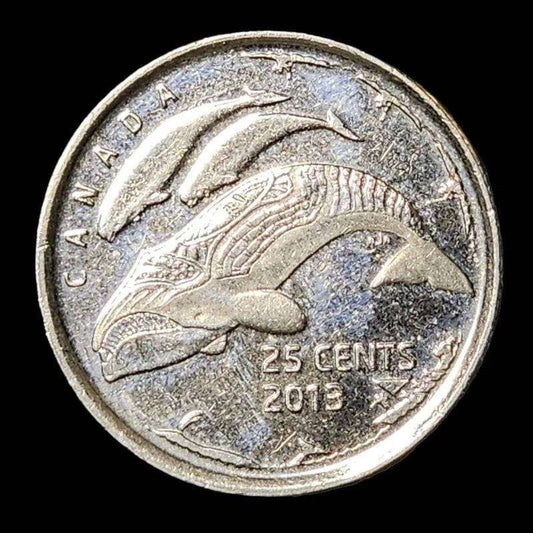 A Canadian coin featuring a whale and fish.