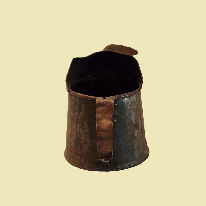 An antique oil can with a lengthy nosle, perfect for tending to automotive needs