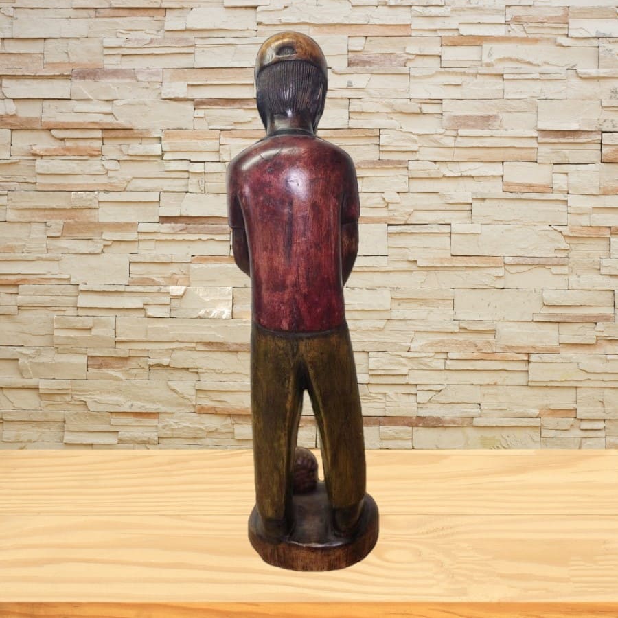 Sculpture of man holding golf club.
