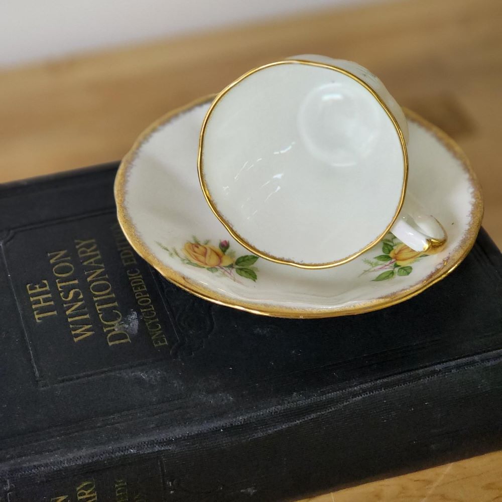 A tea cup and saucer resting on a book, creating a serene and cozy scene.